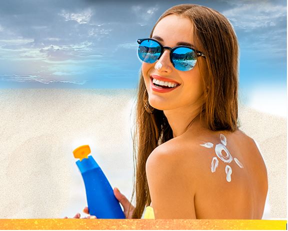 Woman holding sunscreen on beach
